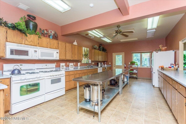 kitchen with white appliances, ceiling fan, brown cabinets, light countertops, and beam ceiling