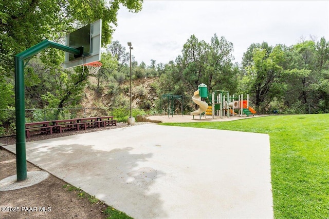 view of basketball court with a yard, playground community, and community basketball court