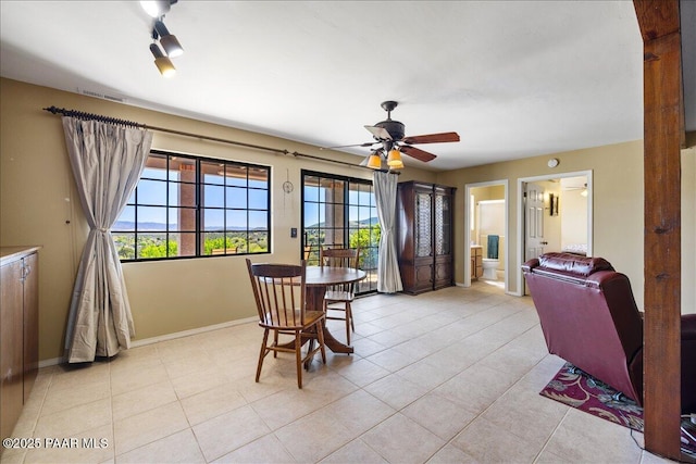 dining room with visible vents, ceiling fan, baseboards, and light tile patterned flooring