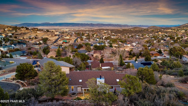aerial view at dusk featuring a residential view and a mountain view