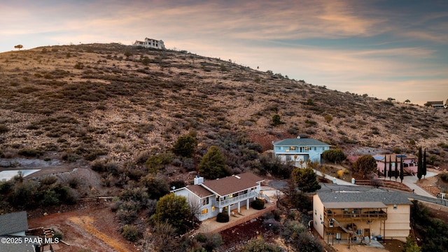 aerial view at dusk featuring a mountain view