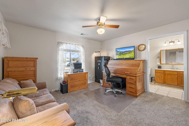 carpeted office space featuring ceiling fan and sink