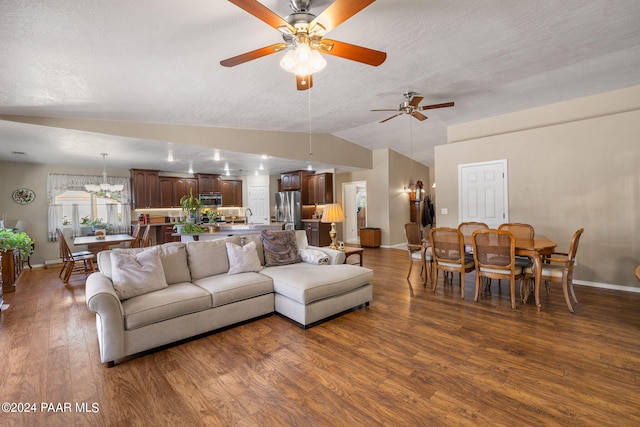 living room with sink, vaulted ceiling, ceiling fan, a textured ceiling, and dark hardwood / wood-style flooring