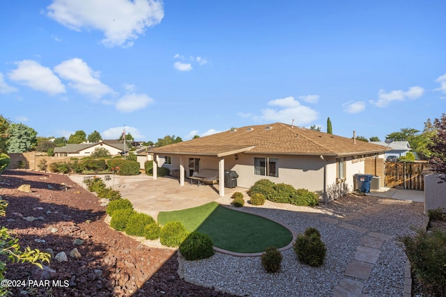 back of property with a patio