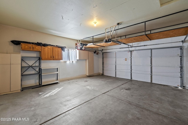 garage with baseboards and a garage door opener