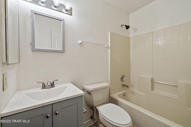 full bathroom with vanity, toilet, washtub / shower combination, and a textured wall