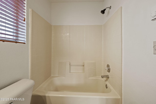 bathroom featuring shower / bathing tub combination and toilet