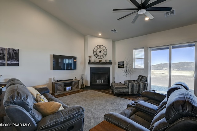 living area with wood finished floors, visible vents, a fireplace, recessed lighting, and ceiling fan