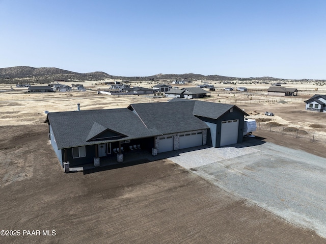 birds eye view of property with a mountain view