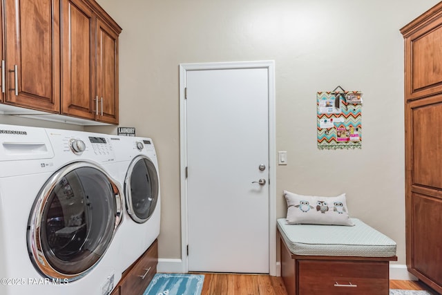 2967 Trail Walk, Prescott, AZ 86301 - laundry area featuring washing machine and clothes dryer, cabinet space, light wood-style flooring, and baseboards