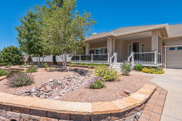 2967 Trail Walk, Prescott, AZ 86301 - view of front of property with covered porch, stucco siding, a garage, and concrete driveway