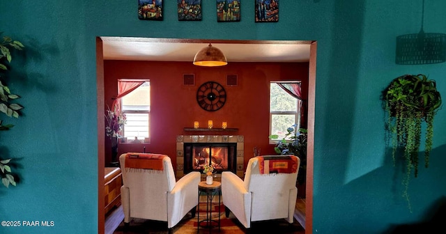 living area with baseboards and wood finished floors