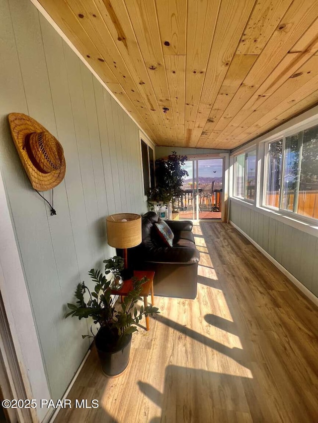 kitchen featuring light wood-style floors, ceiling fan, appliances with stainless steel finishes, light countertops, and decorative light fixtures