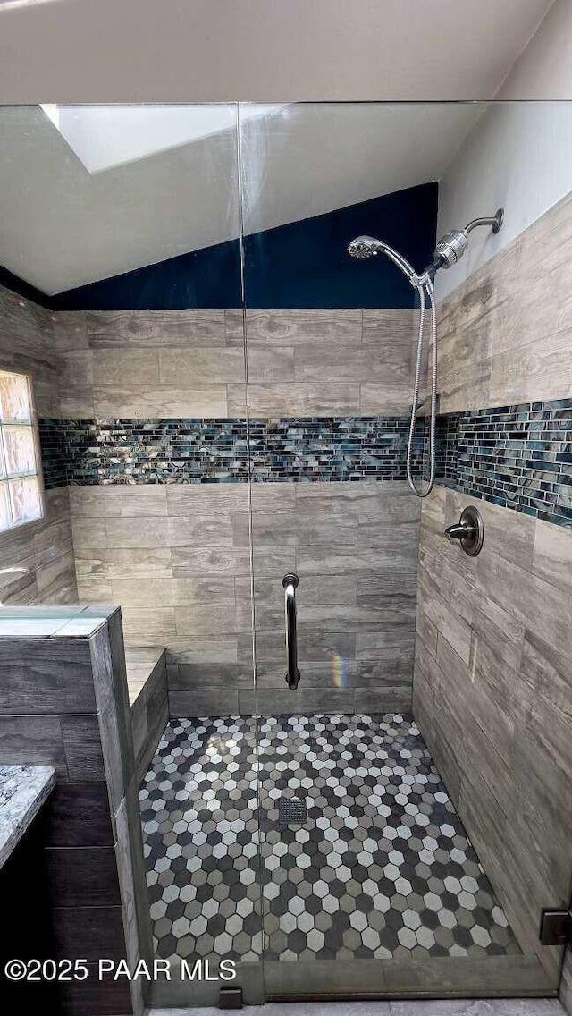bathroom featuring vanity, vaulted ceiling with skylight, toilet, visible vents, and wood finished floors