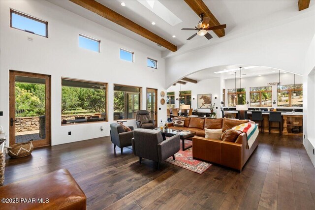15345 N Badlands Cir, Prescott, AZ 86305 - living room with a towering ceiling, beam ceiling, arched walkways, dark wood finished floors, and ceiling fan