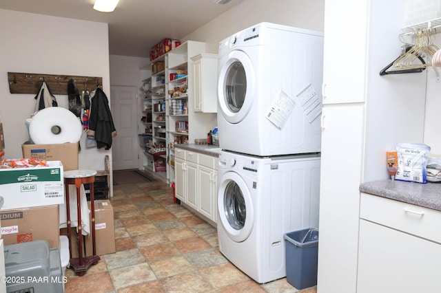 1980 S Koch Ranch Rd, Cornville, AZ 86325 - clothes washing area featuring cabinet space, stacked washer / dryer, and stone finish flooring