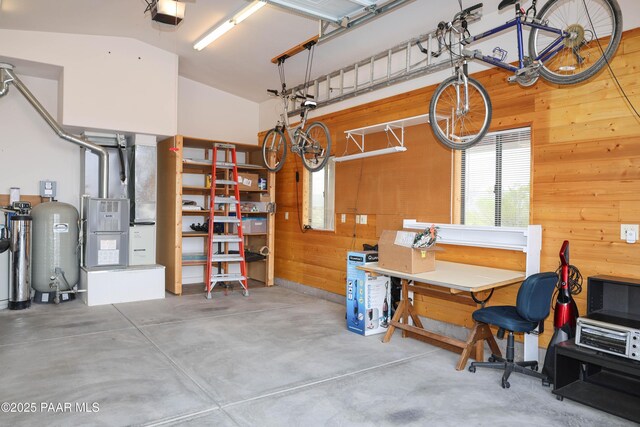 1980 S Koch Ranch Rd, Cornville, AZ 86325 - garage featuring a garage door opener, wood walls, a workshop area, and heating unit