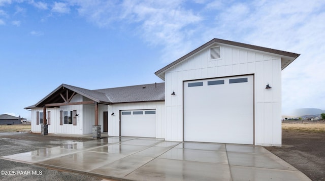 6881 E Bourbon Way, Prescott Valley, AZ 86315 - view of front of home featuring a garage, concrete driveway, roof with shingles, and board and batten siding