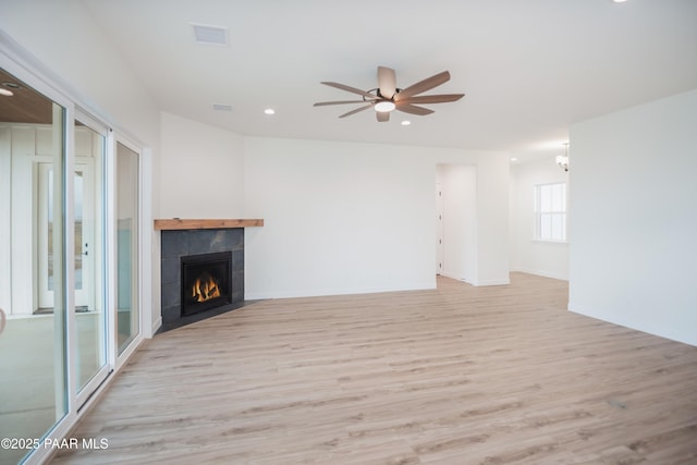 6881 E Bourbon Way, Prescott Valley, AZ 86315 - unfurnished living room featuring wood finished floors, a ceiling fan, a tile fireplace, recessed lighting, and a chandelier