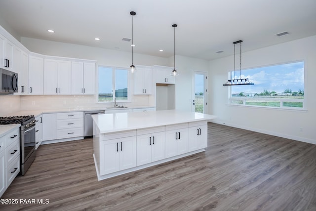 6881 E Bourbon Way, Prescott Valley, AZ 86315 - kitchen featuring stainless steel appliances, backsplash, recessed lighting, wood finished floors, and light countertops