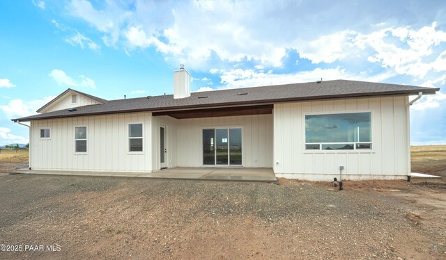 6881 E Bourbon Way, Prescott Valley, AZ 86315 - rear view of house with a chimney, a patio, roof with shingles, and board and batten siding