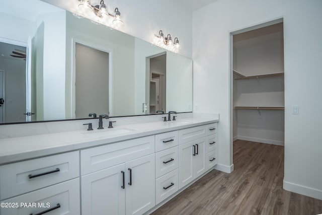 6881 E Bourbon Way, Prescott Valley, AZ 86315 - bathroom featuring double vanity, wood finished floors, and a walk in closet