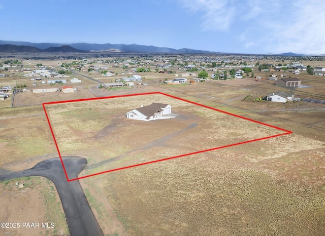 6881 E Bourbon Way, Prescott Valley, AZ 86315 - aerial view of residential area with property parcel outlined and a mountain backdrop