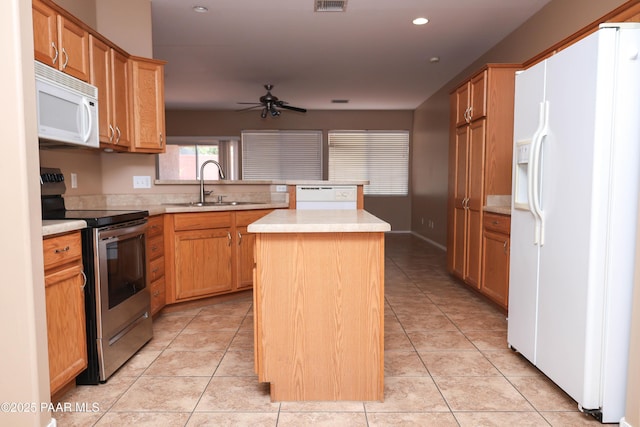 6265 E Distant View Ct, Cornville, AZ 86325 - kitchen featuring white appliances, a kitchen island, ceiling fan, light countertops, and a peninsula