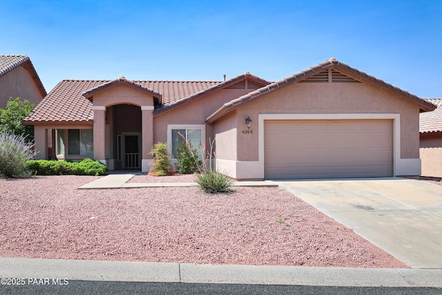 6265 E Distant View Ct, Cornville, AZ 86325 - view of front of property featuring an attached garage, a tile roof, driveway, and stucco siding