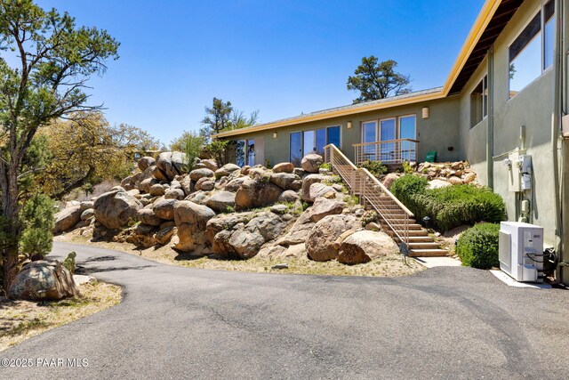 view of front of property with stairway and stucco siding