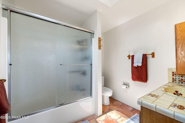 full bath with toilet, vanity, tile patterned floors, and shower / bath combination with glass door