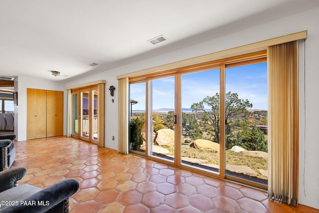 doorway to outside with visible vents and a mountain view