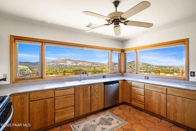 kitchen featuring visible vents, stainless steel dishwasher, range, and light countertops