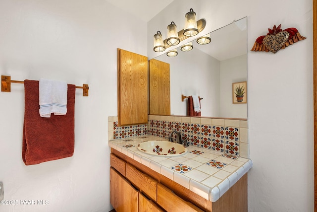 bathroom with vanity and tasteful backsplash