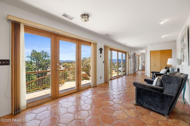 living area featuring a mountain view and visible vents