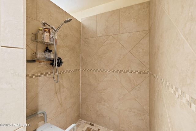 full bath featuring a tile shower