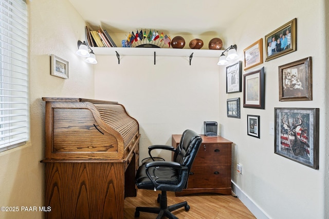 office area with baseboards and wood finished floors