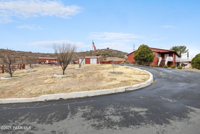 view of front of home with an outbuilding and driveway