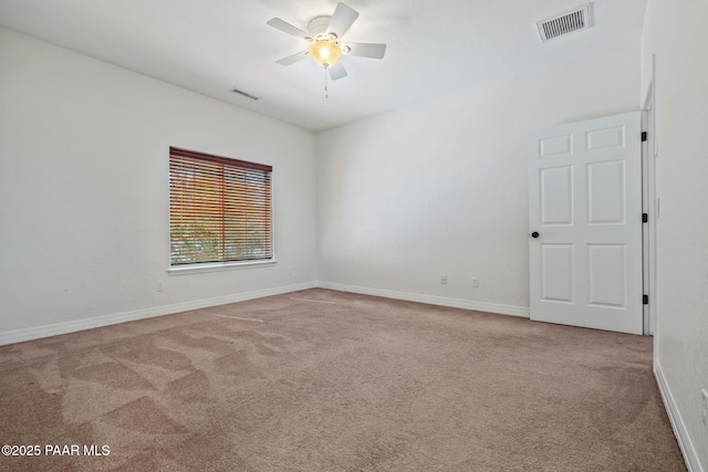 carpeted empty room featuring visible vents, ceiling fan, and baseboards