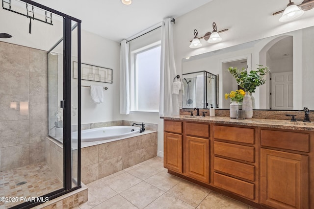 full bath with a shower stall, a bath, a sink, tile patterned floors, and double vanity