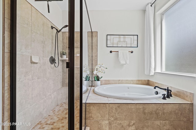 bathroom featuring a bath and a stall shower