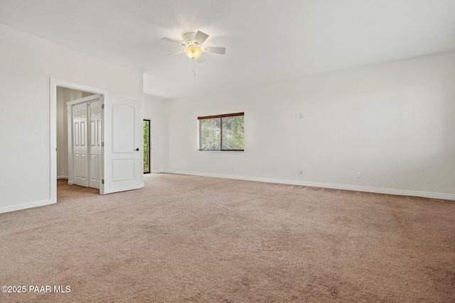 unfurnished room featuring light colored carpet, baseboards, and ceiling fan