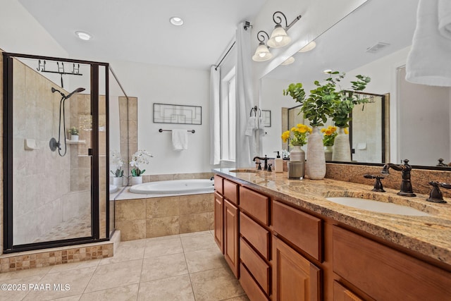 bathroom featuring tile patterned floors, a garden tub, a sink, and a stall shower
