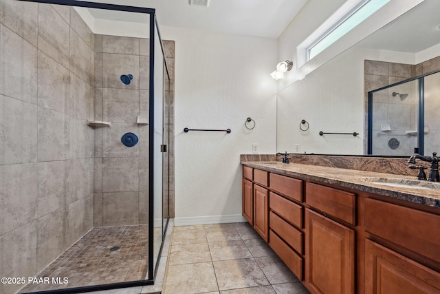 bathroom featuring a stall shower, double vanity, a sink, and tile patterned floors