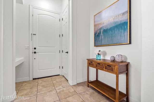 entrance foyer featuring light tile patterned floors and baseboards