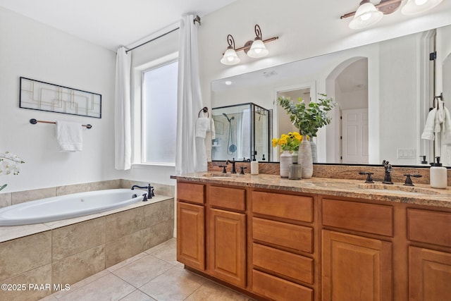 full bathroom featuring a sink, tile patterned floors, a stall shower, and a bath