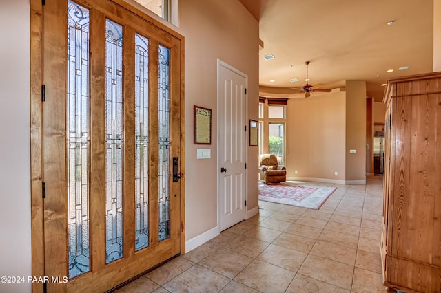 foyer with ceiling fan and light tile patterned floors