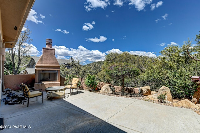 view of patio / terrace featuring an outdoor fireplace