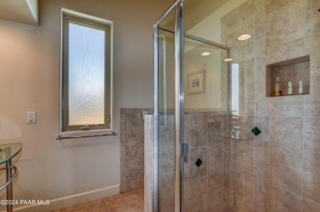 bathroom featuring tile patterned flooring and a shower with door