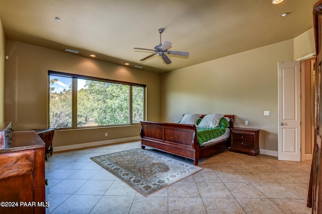 bedroom with ceiling fan and light tile patterned flooring